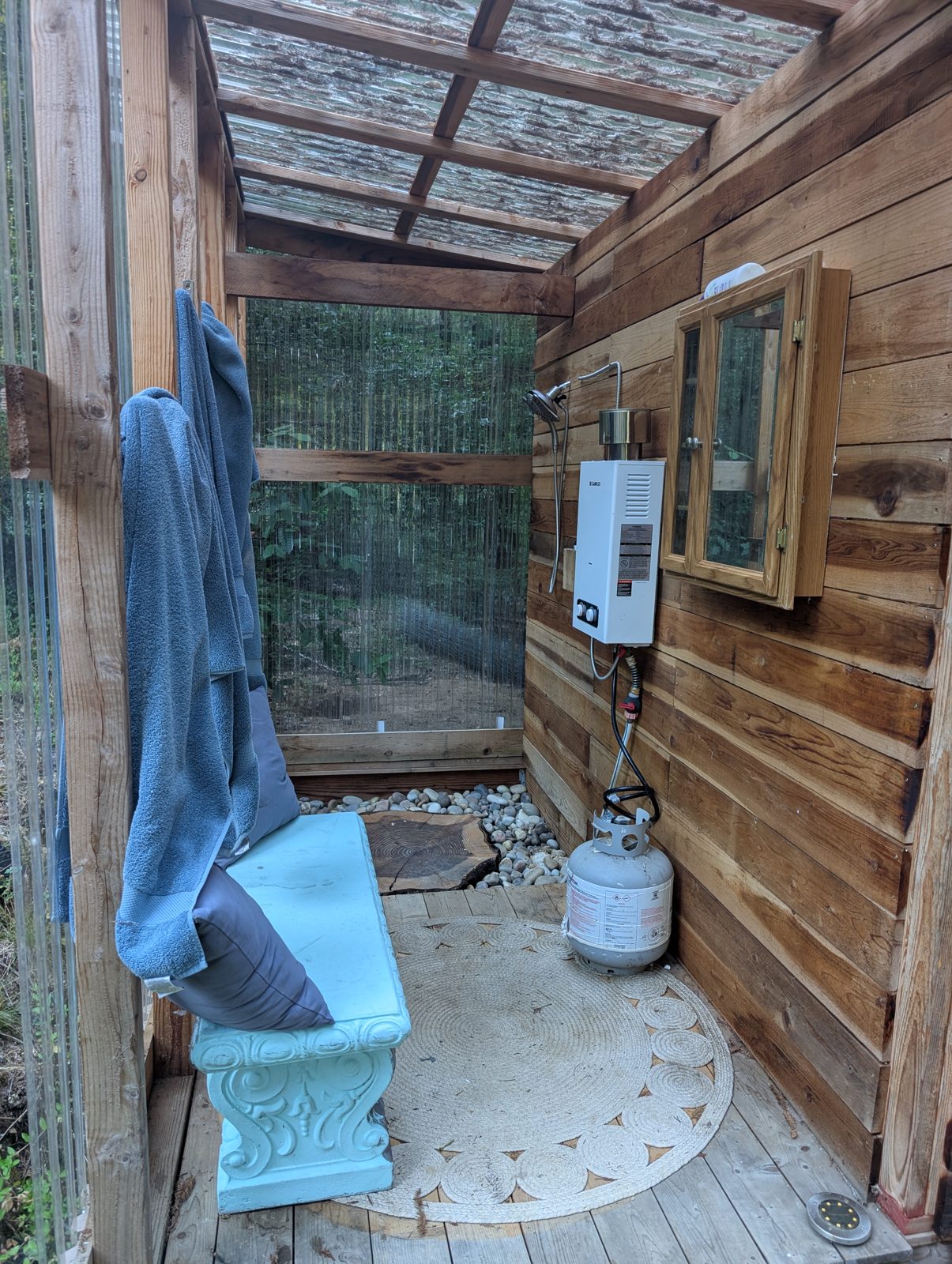 The bathhouse shower, open to the trees